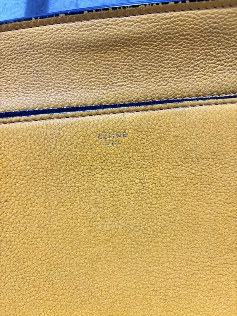 Celine Edge Yellow Leather Top Handle Bag (Category: Luxury Bags & Wallets) located in Muntinlupa City. Submitted by luxurybagprince1 (Listing ID 1443405756, Image 3). Description: - Genuine and authentic yellow Celine handbag - Made from real leather - Front pocket with snap closure - Interior zip pocket - Includes original dust bag - Versatile for everyday or special occasions - A timeless classic - With original dust bag Roughly 11” to 12” W x