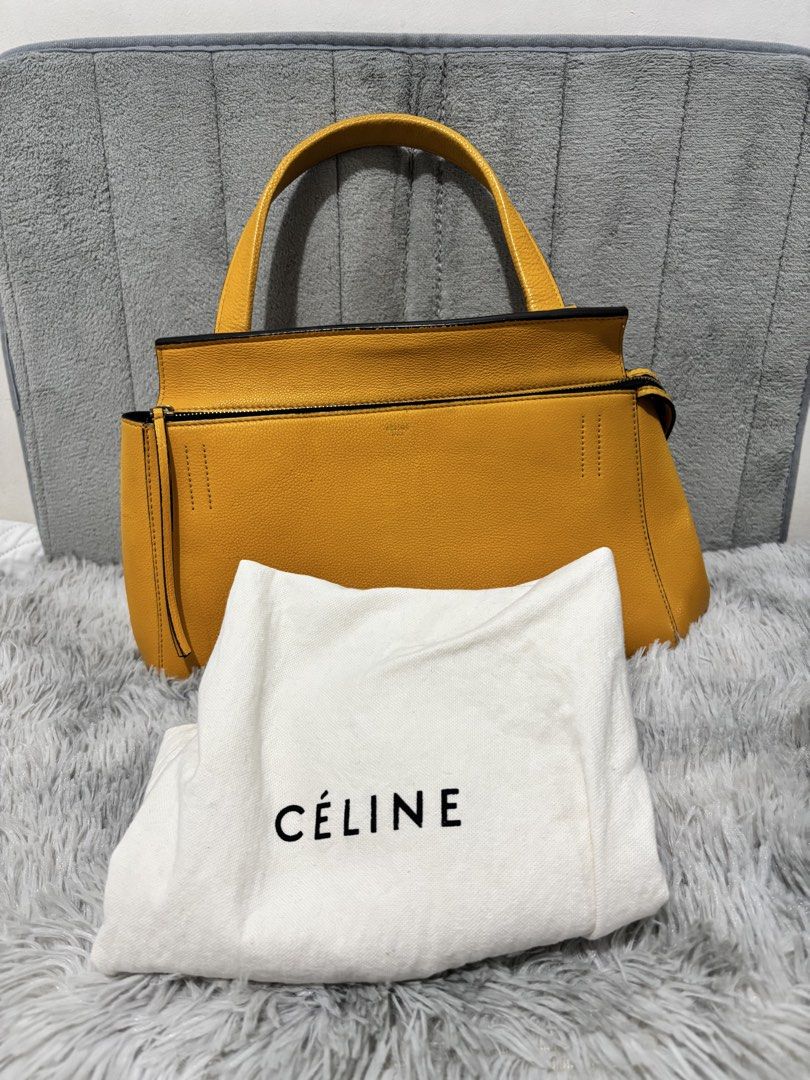 Celine Edge Yellow Leather Top Handle Bag (Category: Luxury Bags & Wallets) located in Muntinlupa City. Submitted by luxurybagprince1 (Listing ID 1443405756, Image 2). Description: - Genuine and authentic yellow Celine handbag - Made from real leather - Front pocket with snap closure - Interior zip pocket - Includes original dust bag - Versatile for everyday or special occasions - A timeless classic - With original dust bag Roughly 11” to 12” W x