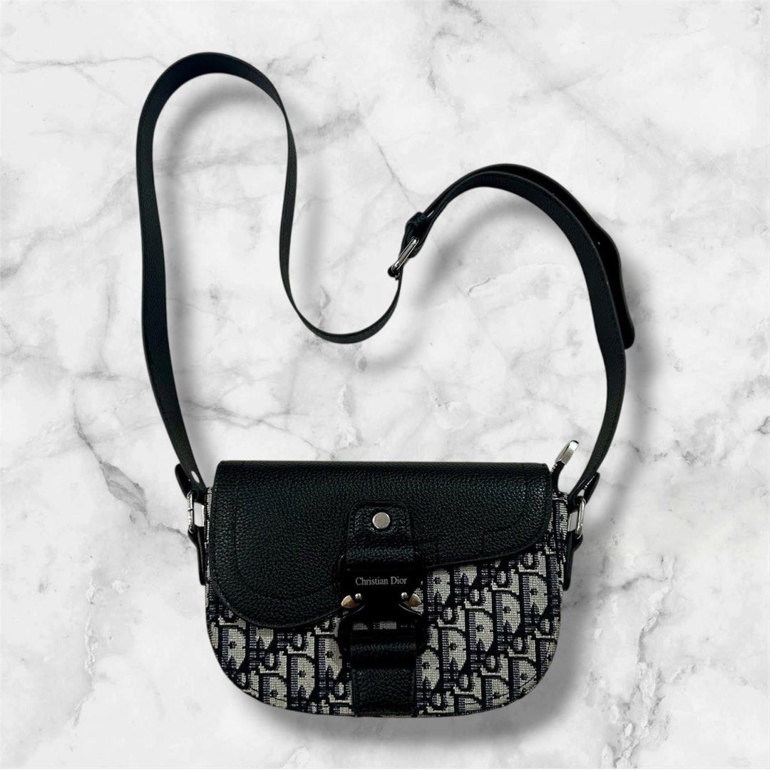 Christian Dior Saddle Bag Oblique Canvas (Category: Luxury Bags & Wallets) located in Manila. Submitted by jcdomdom (Listing ID 1443468476, Image 1). Description: - Iconic Dior saddle bag - Signature Oblique canvas - Black leather trim and strap - Silver hardware with CD clasp - Stylish everyday bag - Ideal for carrying essentials.