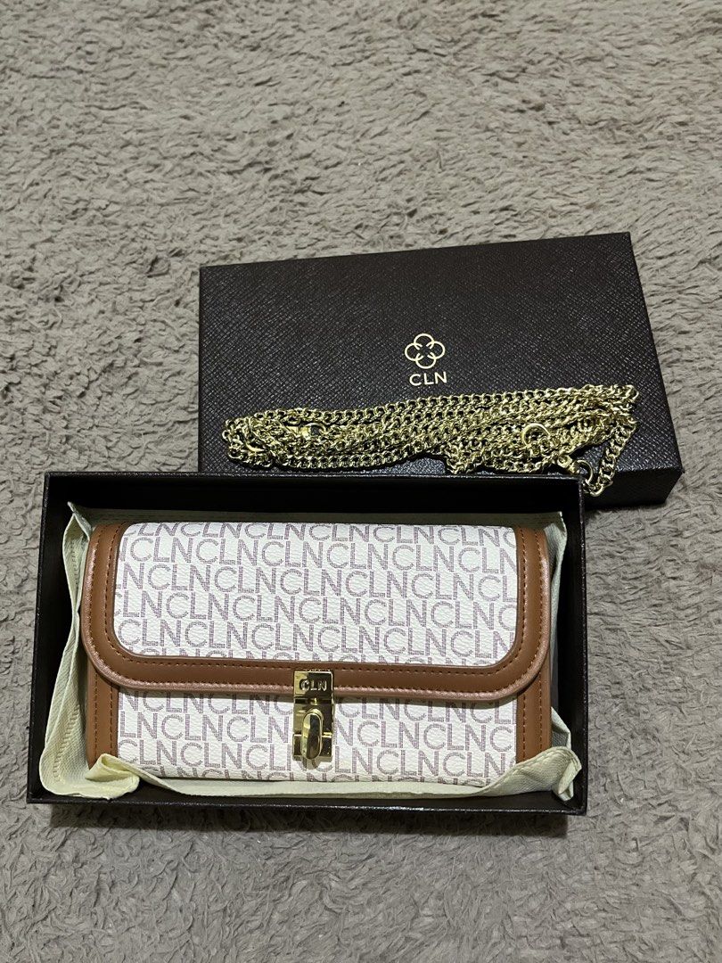 CLN Monogram Wallet Clutch with Gold Chain (Category: Clutches) located in Manila. Submitted by lovedbynixe (Listing ID 1443389041, Image 1). Description: CLN wallet sling with signature monogram print ₱850 Brand new Rfs. Nakadisplay lang - Comes with original box and dust bag - Brown trim and gold hardware - Detachable gold chain strap included - Multiple card slots and zippered compartment inside - Perfect for organizing your essentials.