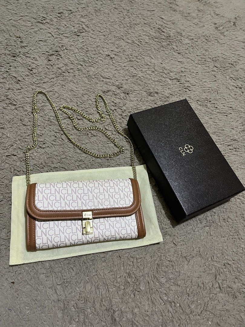 CLN Monogram Wallet Clutch with Gold Chain (Category: Clutches) located in Manila. Submitted by lovedbynixe (Listing ID 1443389041, Image 3). Description: CLN wallet sling with signature monogram print ₱850 Brand new Rfs. Nakadisplay lang - Comes with original box and dust bag - Brown trim and gold hardware - Detachable gold chain strap included - Multiple card slots and zippered compartment inside - Perfect for organizing your essentials.