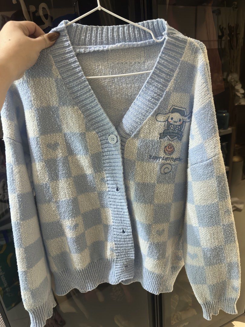 Cute Cinnamoroll Blue Checkered Cardigan (Category: Coats, Jackets and Outerwear) located in Cebu City. Submitted by declutter.queen888 (Listing ID 1443423735, Image 1). Description: - Adorable blue and white checkered cardigan - Features a cute embroidered Cinnamoroll graphic on the front - Easy button-up closure - Made from soft and cozy knit material - Ideal for casual outfits or as a layering piece.