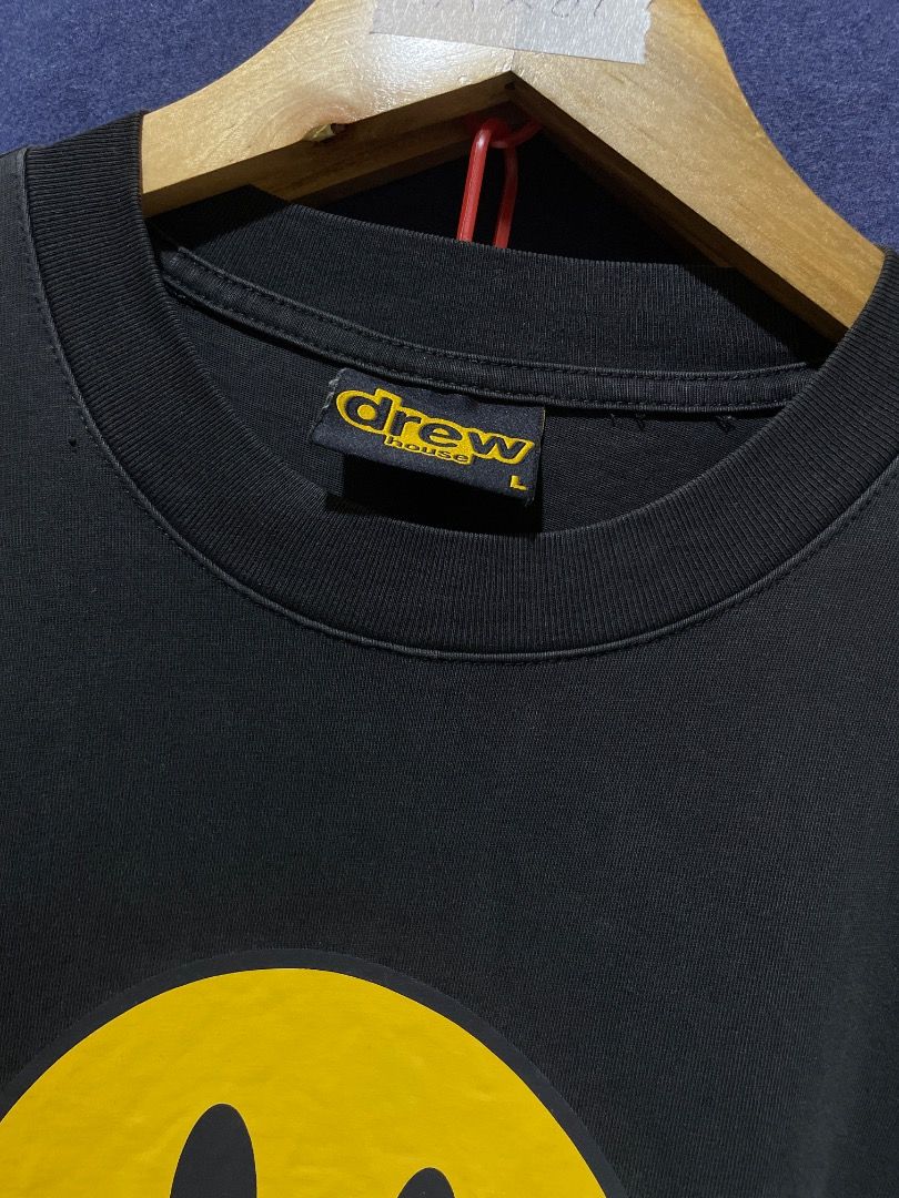 Drew House Black Smiley Face T-Shirt (Category: Tshirts & Polo Shirts ) located in Santa Rosa. Submitted by liamvirtucio_wolf (Listing ID 1443331221, Image 2). Description: - Authentic Black Drew House T-Shirt - Features iconic yellow smiley face graphic - 'drew' text below the smiley - Size: Large (L) - Ideal for everyday casual wear - Please check photos for detailed condition.