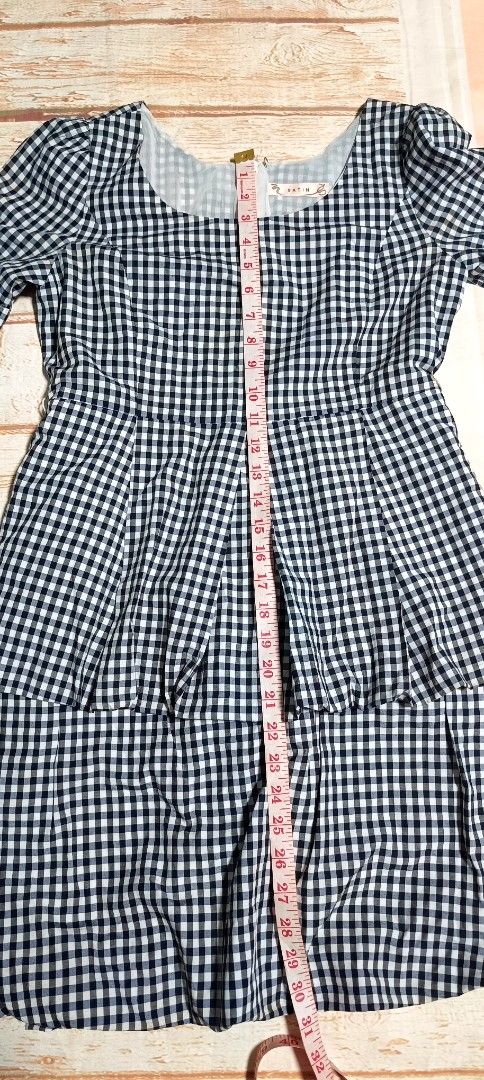 Gingham Tiered Dress with Puff Sleeves (Category: Dresses) located in Davao. Submitted by fabmegashop (Listing ID 1443420596, Image 3). Description: - Adorable black and white gingham pattern - Short puff sleeves for a sweet touch - Flattering tiered skirt design - Bodice features elegant pleating detail - Convenient back zipper closure - Approximate measurements: 17 inches length, 13 inches across the waist - Ideal for casual outings and everyda