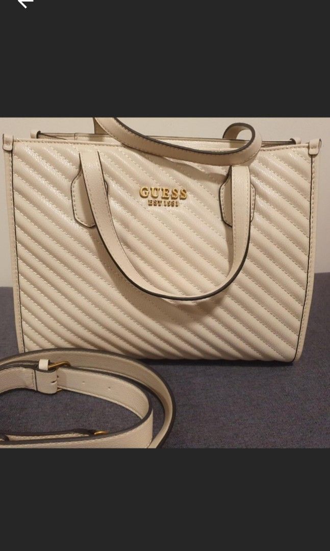 Guess high society quilted satchel bag BRAND NEW! (Category: Bags & Wallets) located in Balmain. Submitted by josephinaglover (Listing ID 1443329036, Image 2). Description: Guess high society quilted satchel handbag cream *BRAND NEW* with dustbag please note- I have included photos of a very similar bag (slightly smaller with different strap for styling purposes, please see all photos to see the original bag for Sale) #guess #luxurybags#designer#