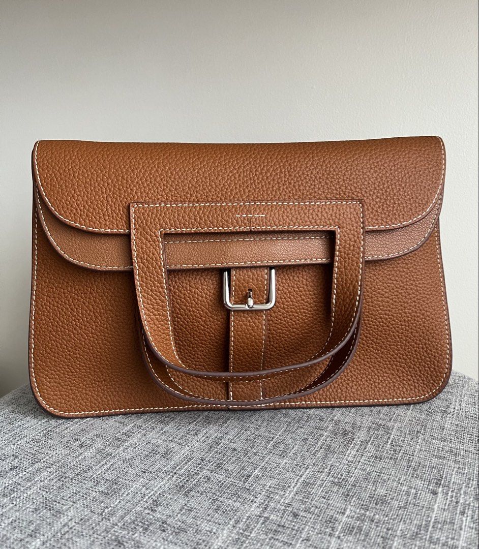 Hermes Halzan 25 (Category: Shoulder Bags) located in Pasig City. Submitted by declutterwithme11 (Listing ID 1443362703, Image 1). Description: - Brand new condition. 10/10. - Coded. 1 is to 1. - Genuine leather. Gold color on silver hardware. - Size 25/Small - Inclusions: Strap, dust bag, and cards. I won’t accept returns and refunds, so please triple check the item before buying. DM me for more detailed photos..