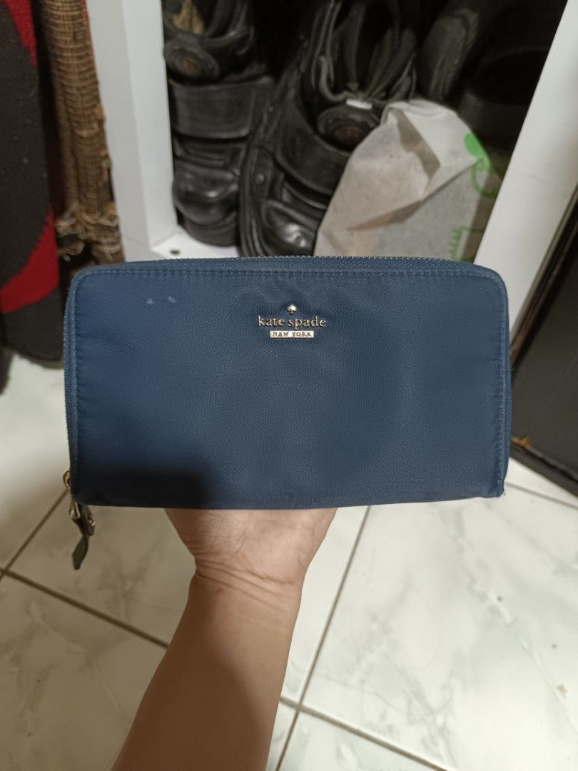 Kate Spade Navy Blue Nylon Zip Around Wallet (Category: Wallets & Card holders) located in Manila. Submitted by caaths_collection (Listing ID 1443424663, Image 1). Description: - Navy blue Kate Spade wallet - Durable nylon material - Secure zip-around closure - Spacious interior for cards and cash - Elegant gold-tone hardware - Ideal for everyday use.
