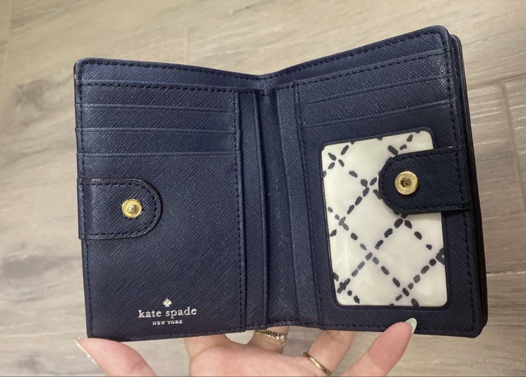 Kate Spade Navy Blue Saffiano Leather Wallet (Category: Wallets & Card holders) located in Manila. Submitted by mtomas1222 (Listing ID 1443409231, Image 2). Description: - Original Navy blue Kate Spade wallet - Genuine saffiano leather exterior - Interior features multiple card slots - Dedicated coin pouch with zipper closure - Secure snap closure for main wallet - Elegant gold hardware details -Good as new -with paper bag .