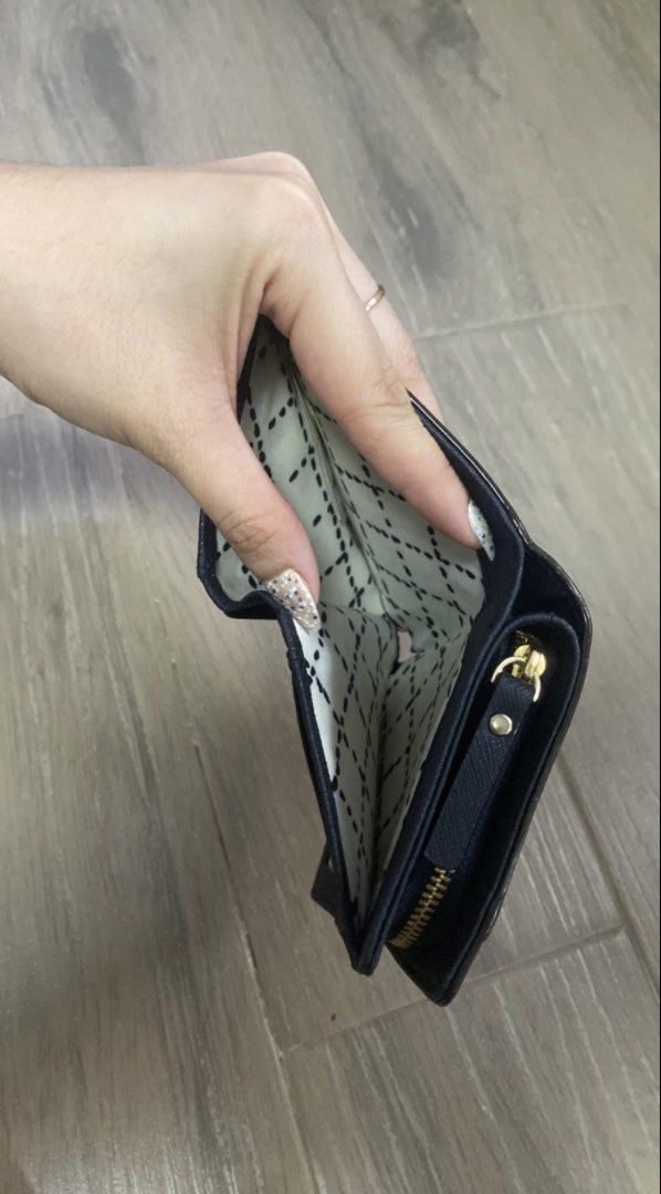 Kate Spade Navy Blue Saffiano Leather Wallet (Category: Wallets & Card holders) located in Manila. Submitted by mtomas1222 (Listing ID 1443409231, Image 3). Description: - Original Navy blue Kate Spade wallet - Genuine saffiano leather exterior - Interior features multiple card slots - Dedicated coin pouch with zipper closure - Secure snap closure for main wallet - Elegant gold hardware details -Good as new -with paper bag .