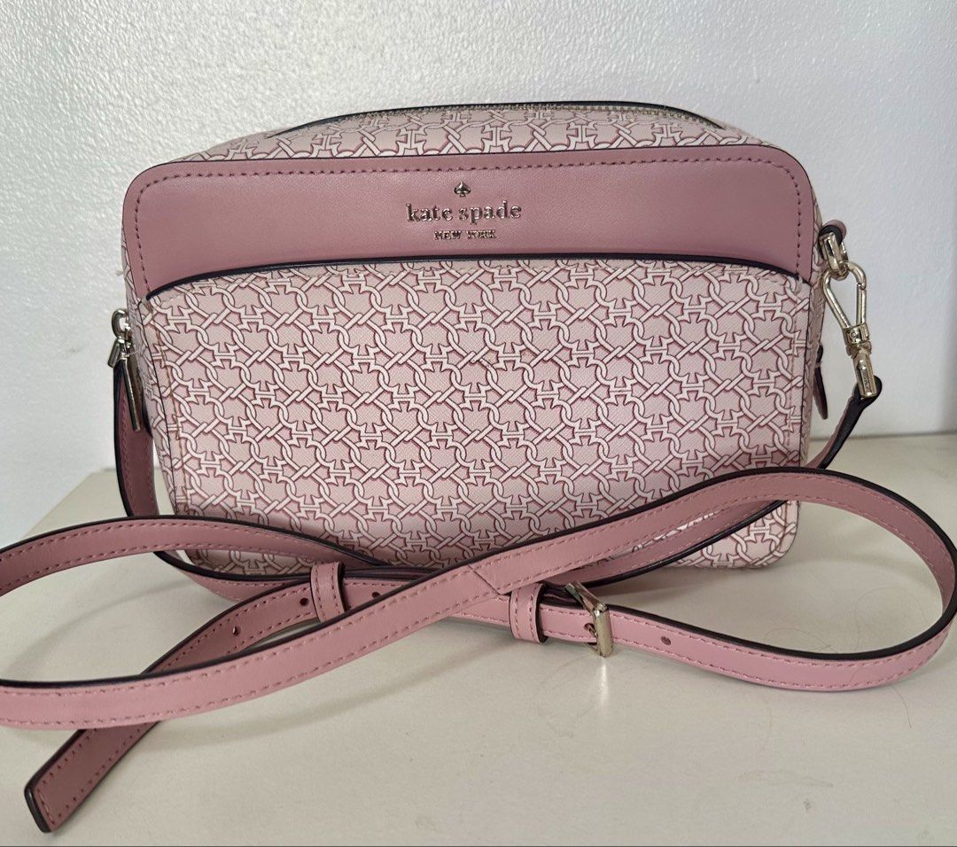 Kate Spade Pink Link Crossbody Bag (Category: Cross-body Bags) located in Mandaluyong City. Submitted by mabv85 (Listing ID 1443373586, Image 1). Description: - Authentic Kate Spade pink crossbody bag - Pink with white chain link print - Zip top closure - Front flap pocket - Interior spade print lining - Adjustable strap - Dimensions in inches: 6”H x 9”W x 2.5”D.