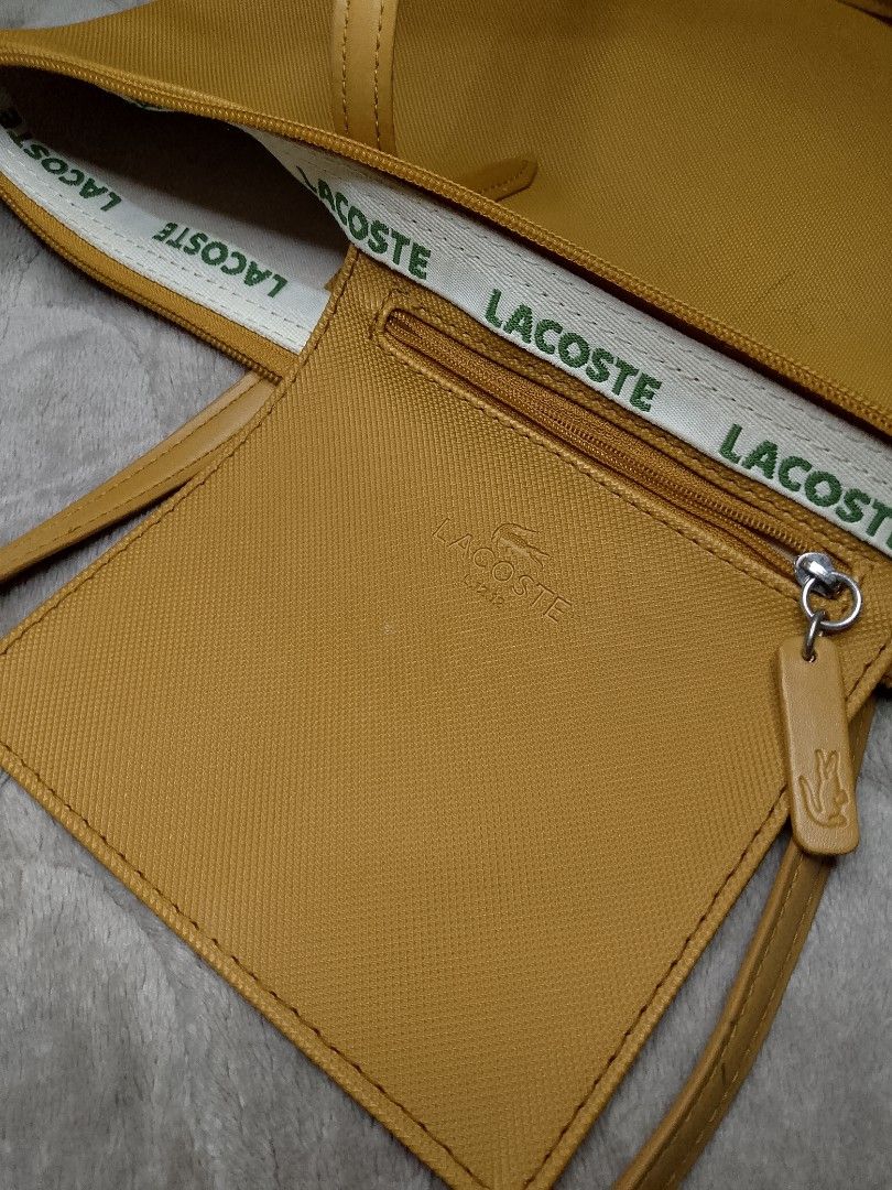 LACOSTE CONCEPT TOTE BAG (Category: Luxury Bags & Wallets) located in Angeles City. Submitted by recycledcloset2.0 (Listing ID 1443412299, Image 3). Description: For sale !! Lacoste Concept Tote bag Good condition Need Deep wash(stains) Pen stains , Food stain Missing main zipper Complete tags Authentic 💯 Color rate 9.5/10 This large, lightweight zipped tote is big enough to hold a 15” laptop. The star of the L.12.12 Concept collection, featurin