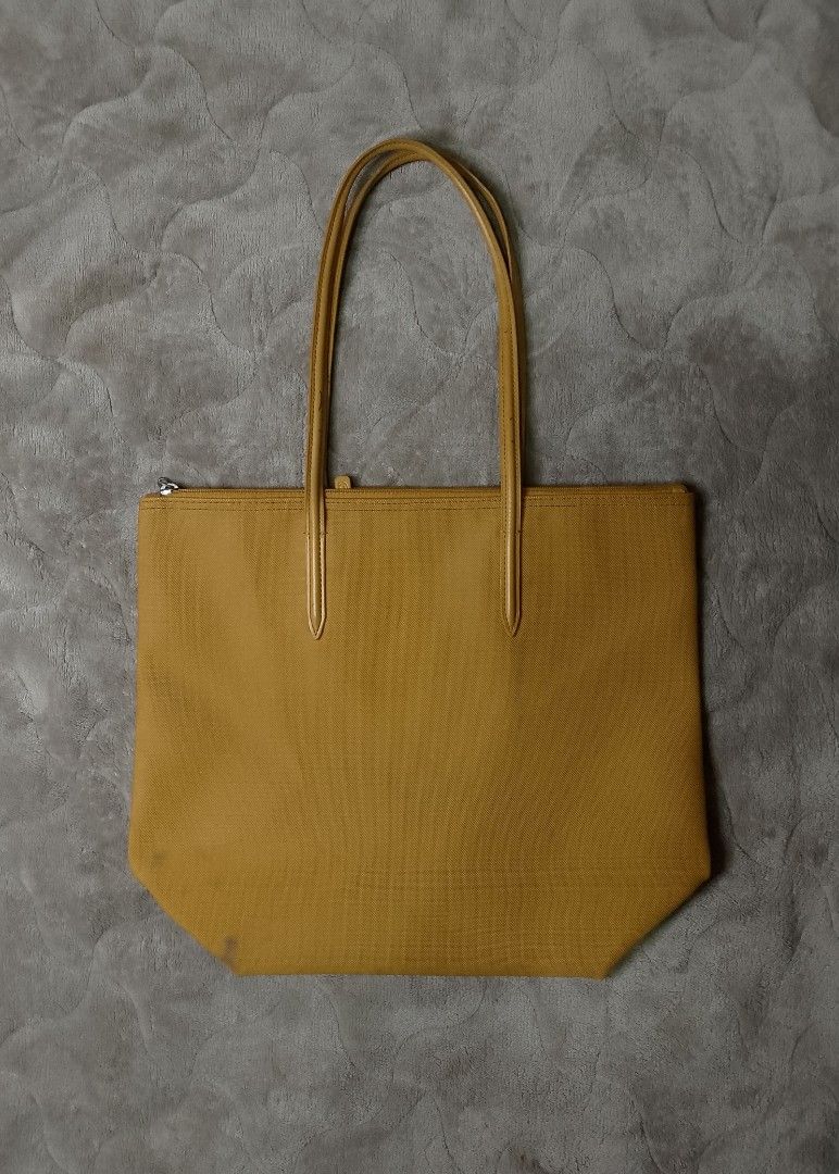 LACOSTE CONCEPT TOTE BAG (Category: Luxury Bags & Wallets) located in Angeles City. Submitted by recycledcloset2.0 (Listing ID 1443412299, Image 2). Description: For sale !! Lacoste Concept Tote bag Good condition Need Deep wash(stains) Pen stains , Food stain Missing main zipper Complete tags Authentic 💯 Color rate 9.5/10 This large, lightweight zipped tote is big enough to hold a 15” laptop. The star of the L.12.12 Concept collection, featurin