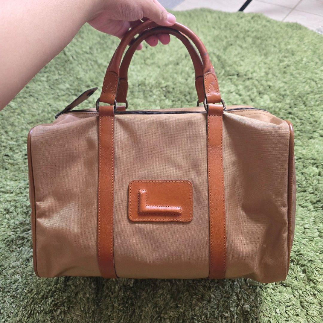 Lancel Paris Boston Bag (Category: Luxury Bags & Wallets) located in Pasig City. Submitted by millennialthrifter (Listing ID 1443327366, Image 1). Description: ✴️LANCEL BOSTON BAG - 1200 PESOS ONLY❗ ✅Brand: Lancel Paris (Made in France) ✅Good and clean condition 👌 Brand new price reference: around 11k (see comment section) 🌸pm us for the video.