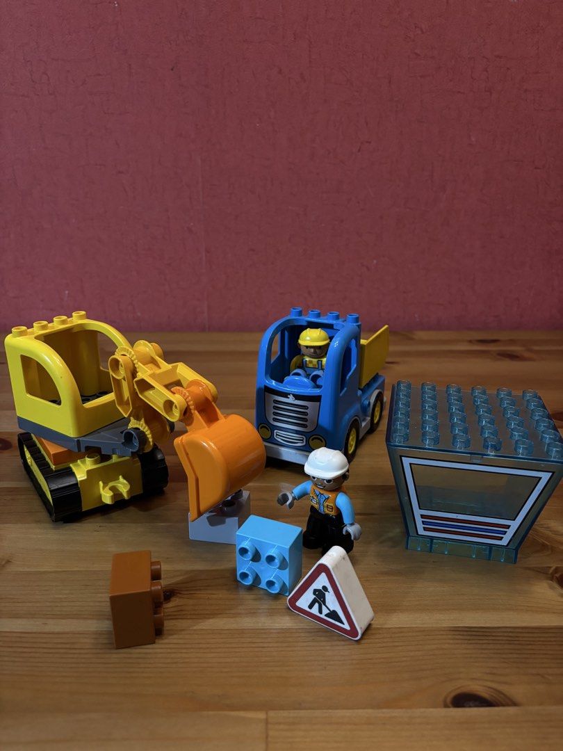 LEGO Duplo Construction Vehicles and Figures Set (Category: Lego & Building Sets) located in Paranaque City. Submitted by avec21 (Listing ID 1443411815, Image 2). Description: - Yellow excavator and blue truck included. - Construction worker figures for interactive play. - Building blocks and road sign for creative construction. - All pieces shown in the photos are included. - Perfect for sparking imaginative play for little builders..