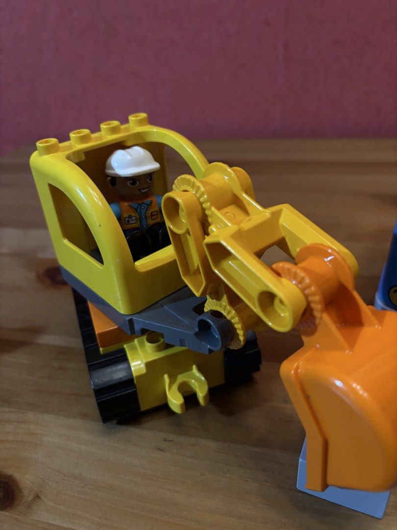 LEGO Duplo Construction Vehicles and Figures Set (Category: Lego & Building Sets) located in Paranaque City. Submitted by avec21 (Listing ID 1443411815, Image 3). Description: - Yellow excavator and blue truck included. - Construction worker figures for interactive play. - Building blocks and road sign for creative construction. - All pieces shown in the photos are included. - Perfect for sparking imaginative play for little builders..
