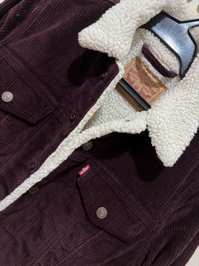 Levi's Corduroy Sherpa Lined Trucker Jacket (Category: Coats, Jackets and Outerwear) located in Candelaria. Submitted by mnloangel (Listing ID 1443447153, Image 2). Description: - Classic Levi's corduroy jacket - Rich burgundy color - Warm sherpa lining for ultimate coziness - Two button-closure chest pockets - Two convenient side pockets - Secure button front closure - Ideal for cooler weather and layering - Sharp, timeless style.