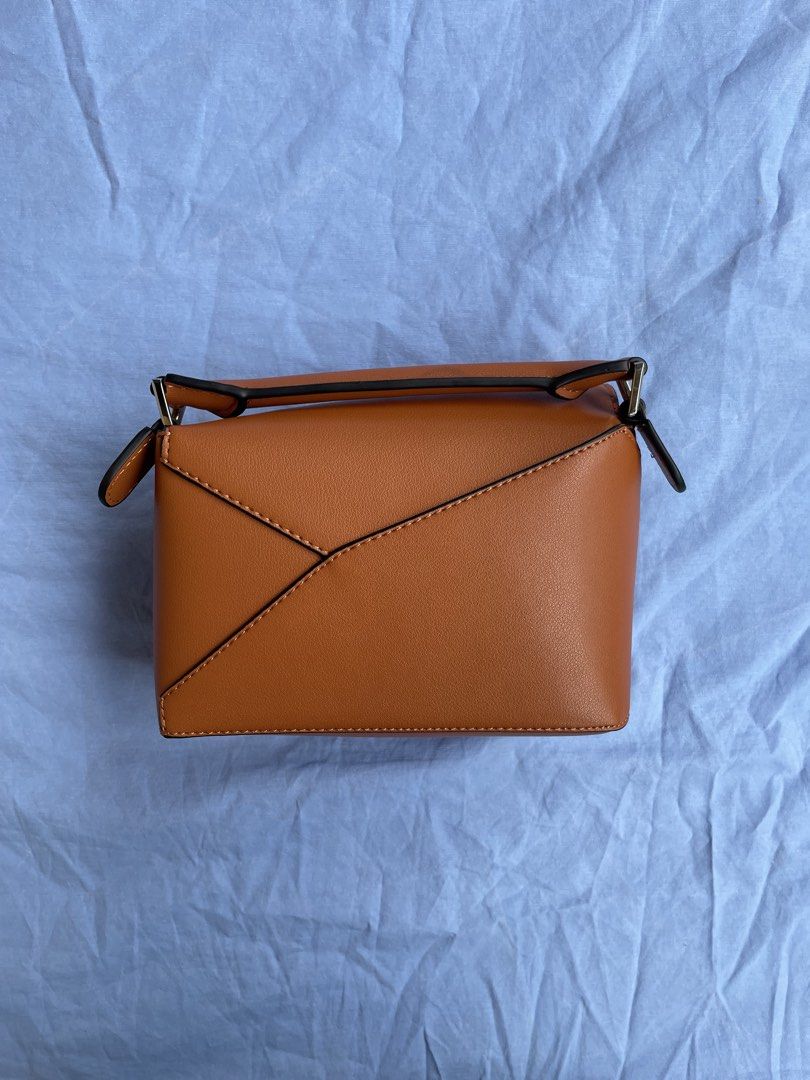 Loewe Puzzle Bag Mini Tan Leather (Category: Luxury Bags & Wallets) located in Quezon City. Submitted by sheen_calanza (Listing ID 1443476386, Image 3). Description: - Authentic Loewe Puzzle Bag - Color: Tan - Size: Small - Material: Genuine Leather - Origin: Made in Spain - Closure: Zipper inside - Style: Minimalist, perfect for everyday use - Thrifted in Japan - Can do meet ups .