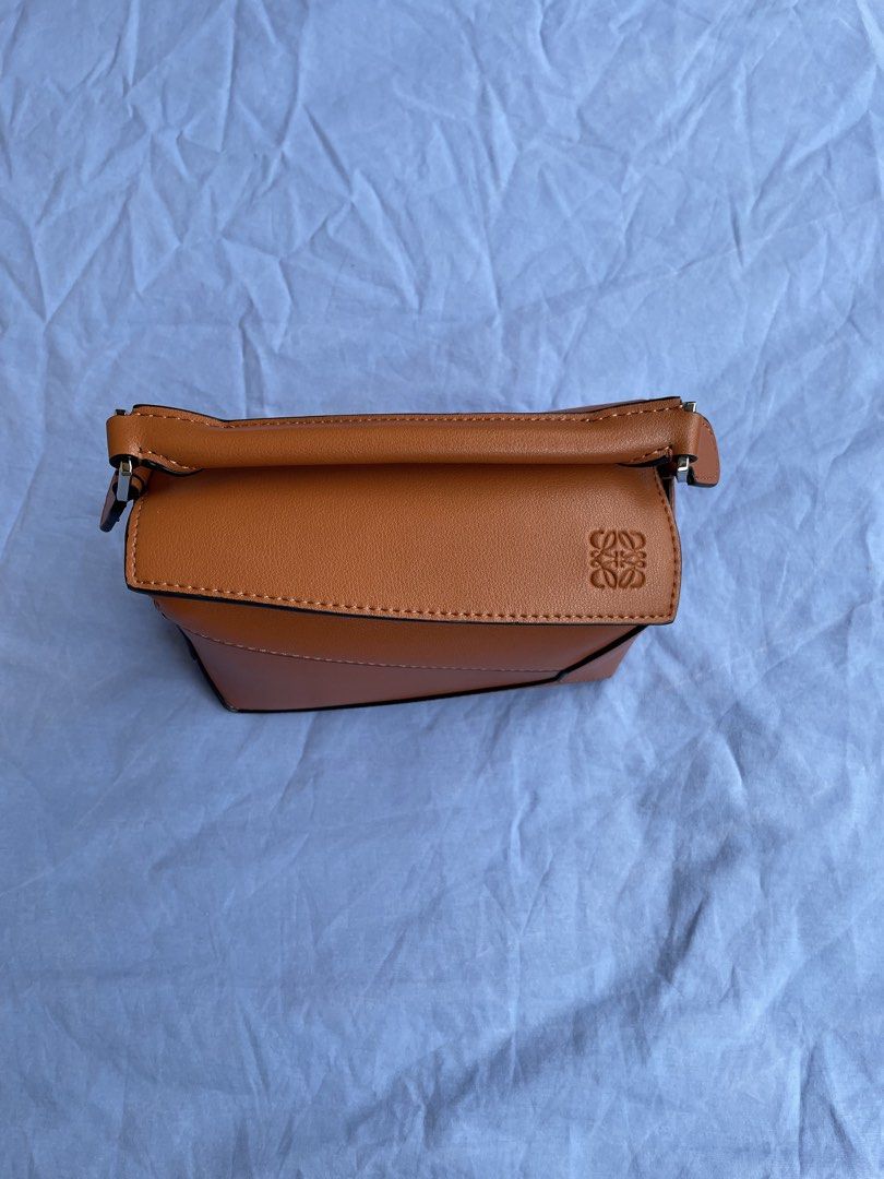 Loewe Puzzle Bag Mini Tan Leather (Category: Luxury Bags & Wallets) located in Quezon City. Submitted by sheen_calanza (Listing ID 1443476386, Image 2). Description: - Authentic Loewe Puzzle Bag - Color: Tan - Size: Small - Material: Genuine Leather - Origin: Made in Spain - Closure: Zipper inside - Style: Minimalist, perfect for everyday use - Thrifted in Japan - Can do meet ups .