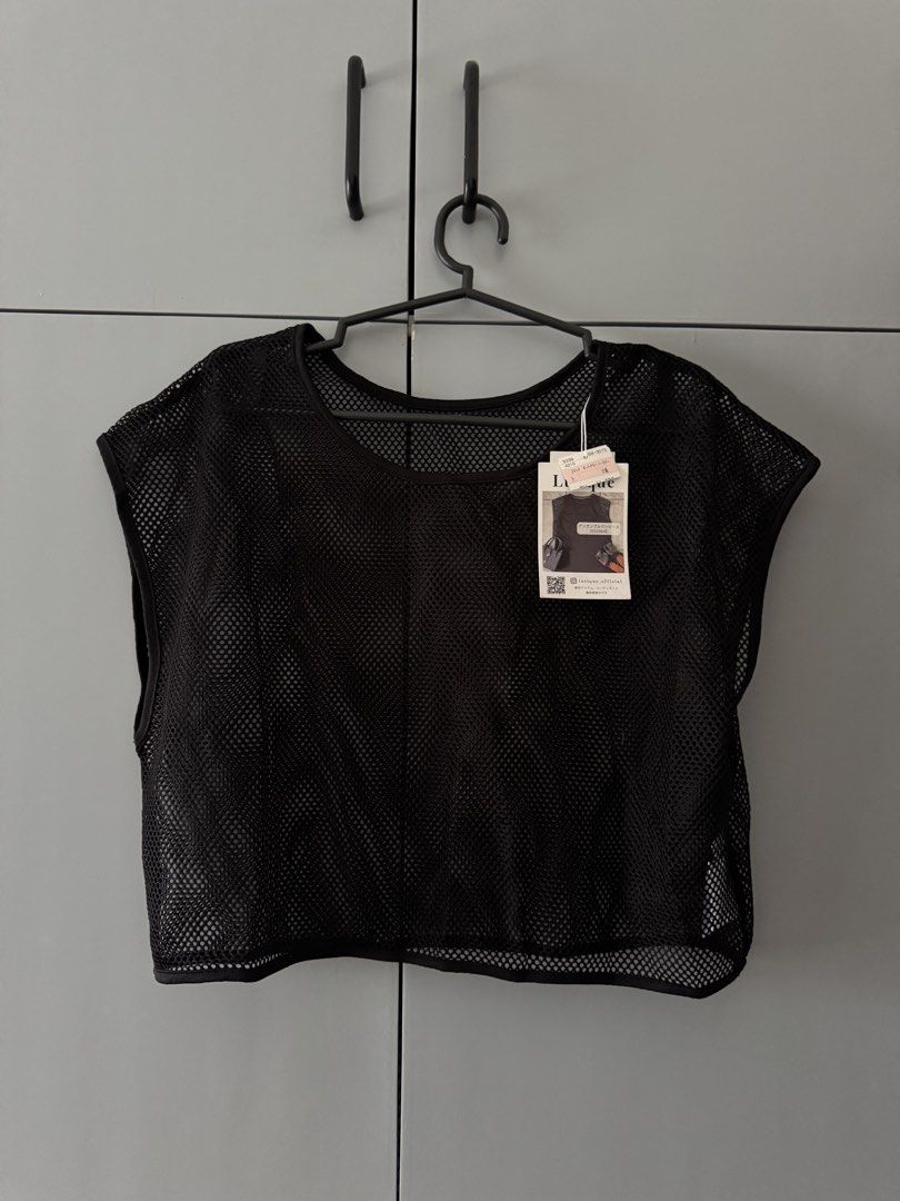 Lutique Black Net Sleeveless Crop Top (Category: Sleeveless) located in Santa Rosa. Submitted by natgraphs (Listing ID 1443380977, Image 1). Description: - Brand: L'EQUIPE - Style: Sleeveless crop top - Material: Black mesh with unique texture - Features: Great for layering over other tops or bralettes - Occasion: Suitable for casual wear or a night out.