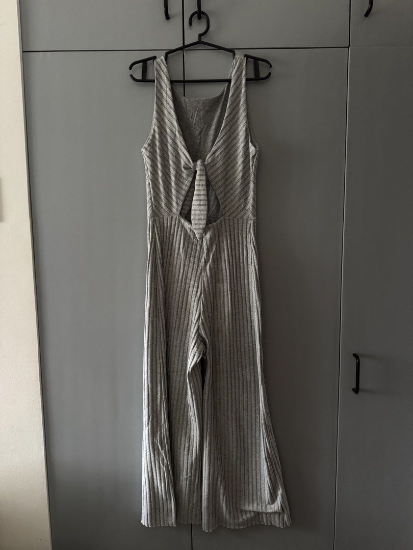 Mango Grey Ribbed Jumpsuit with Back Tie Detail (Category: Jumpsuits) located in Santa Rosa. Submitted by natgraphs (Listing ID 1443380690, Image 2). Description: - Fits XS-M - Grey ribbed jumpsuit - Thin white stripes - Sleeveless with V-neckline - Front tie detail with cut-out - Wide leg pants - Versatile for casual or night out.