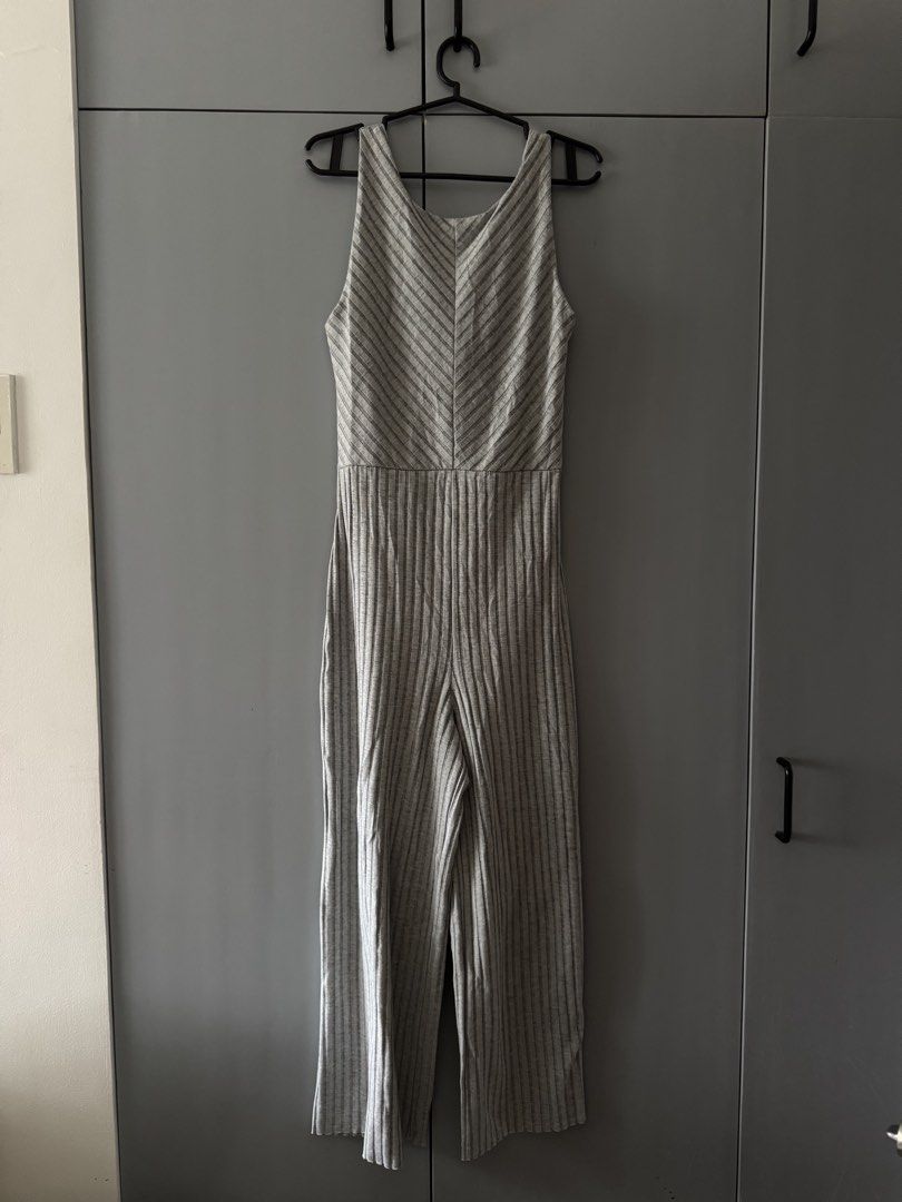 Mango Grey Ribbed Jumpsuit with Back Tie Detail (Category: Jumpsuits) located in Santa Rosa. Submitted by natgraphs (Listing ID 1443380690, Image 1). Description: - Fits XS-M - Grey ribbed jumpsuit - Thin white stripes - Sleeveless with V-neckline - Front tie detail with cut-out - Wide leg pants - Versatile for casual or night out.