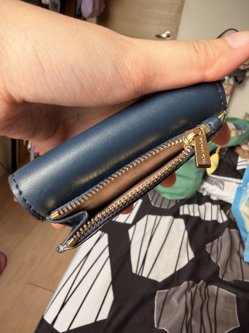 Michael Kors Navy Blue Leather Key Holder Pouch (Category: Wallets & Card holders) located in Quezon City. Submitted by oddflower.989507 (Listing ID 1443398488, Image 2). Description: - Authentic Michael Kors navy blue leather key holder. - Features multiple key hooks for organization. - Includes a small zippered compartment for essentials. - Elegant gold hardware details. - Interior and exterior are clean and well-maintained. - Perfect for keepi