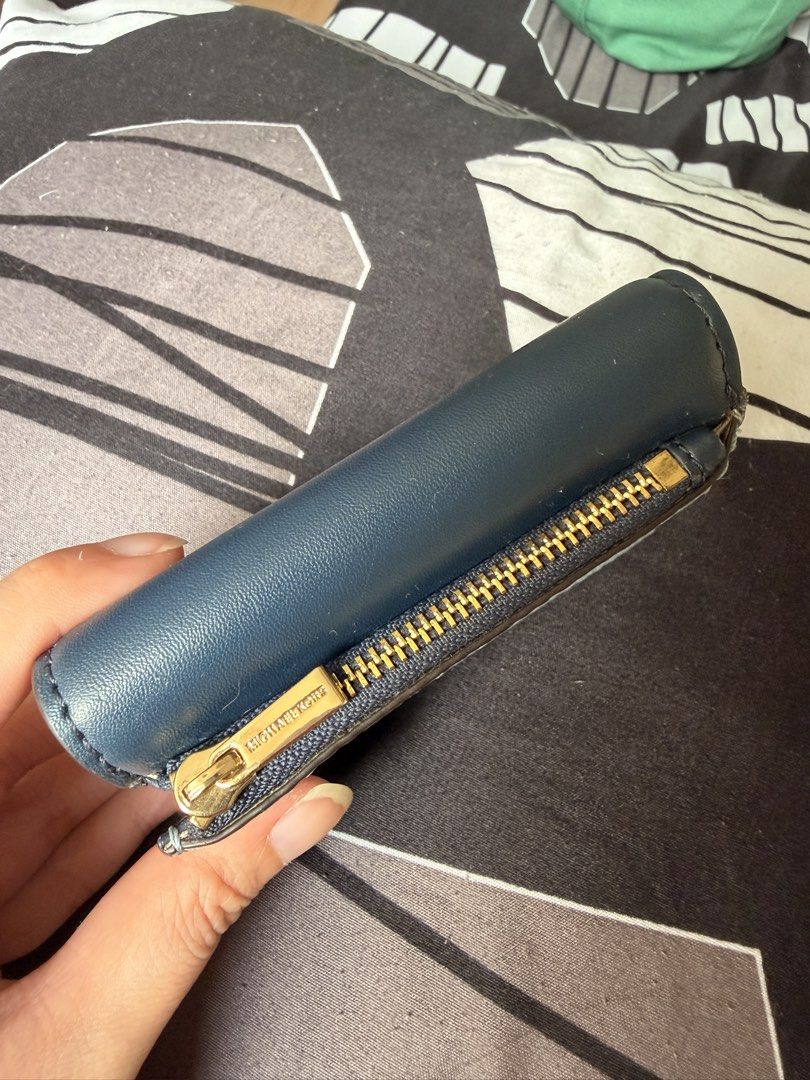 Michael Kors Navy Blue Leather Key Holder Pouch (Category: Wallets & Card holders) located in Quezon City. Submitted by oddflower.989507 (Listing ID 1443398488, Image 3). Description: - Authentic Michael Kors navy blue leather key holder. - Features multiple key hooks for organization. - Includes a small zippered compartment for essentials. - Elegant gold hardware details. - Interior and exterior are clean and well-maintained. - Perfect for keepi