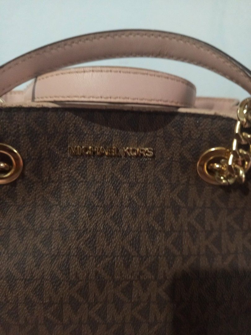 Michael Kors Teagen messenger leather bag authentic (Category: Luxury Bags & Wallets) located in Gapan. Submitted by cristina_adofina (Listing ID 1443387898, Image 2). Description: - Authentic Michael Kors handbag - Signature brown monogram print - Light pink leather accents - Gold chain details - Top handles - Detachable shoulder strap - Multiple interior compartments - Magnetic snap closure - Stylish everyday bag.