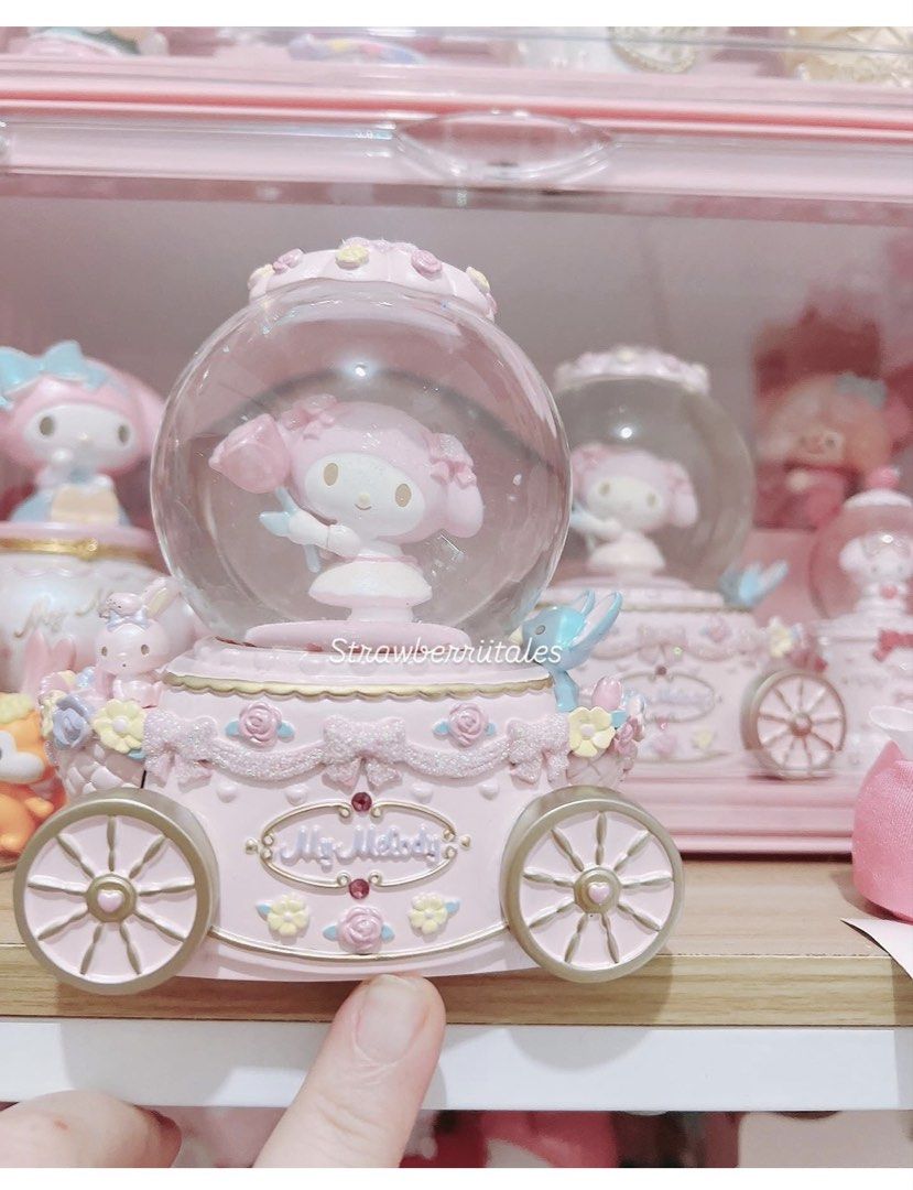 My Melody Pink Carriage Snow Globe (Category: Vintage Collectibles) located in Manila. Submitted by maimero (Listing ID 1443411264, Image 1). Description: - Pink carriage design with wheels - Features a snow globe on top with My Melody holding a flower - Decorated with roses and gems - Perfect addition to any My Melody fan's collection.