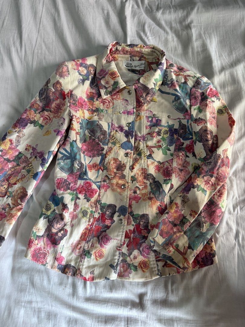 Nga Pui Collection Floral Print Denim Jacket (Category: Coats, Jackets and Outerwear) located in Pasay City. Submitted by idaboutique (Listing ID 1443438776, Image 1). Description: - Unique denim jacket with vibrant all-over floral and doll print. - Features a classic button-up front. - Includes convenient chest pockets. - Perfect statement piece to elevate your style. - Adds flair and personality to any outfit..