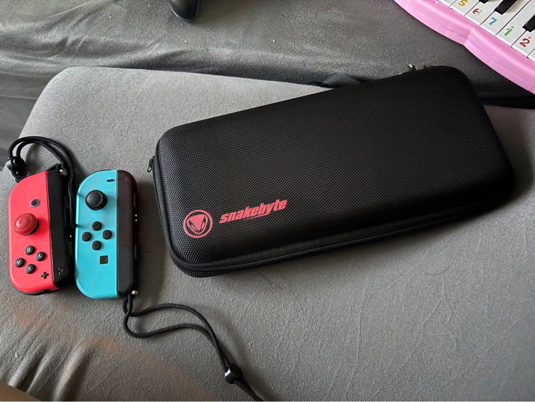 Nintendo Switch Console with Joy-Cons and Case (Category: Nintendo) located in Quezon City. Submitted by archer417 (Listing ID 1443413616, Image 2). Description: - Nintendo Switch Console with dock and charger - 2 Red and 2 Blue Joy-Cons included - Black Carrying Case - Ideal for portable gaming - Feel free to ask questions!.