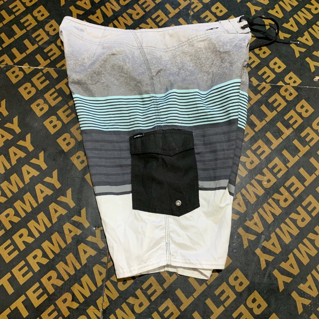 O'Neill Board Shorts Size 32 (Category: Swim Trunks & Board Shorts) located in Cebu City. Submitted by stuff_paid (Listing ID 1443332601, Image 2). Description: - Brand: O'Neill - Size: 32 - Material: 100% Polyester - Features: Black cargo pocket on the side, drawstring waist - Design: Striped pattern with grey, black, and light blue - Ideal for: Swimming, surfing.
