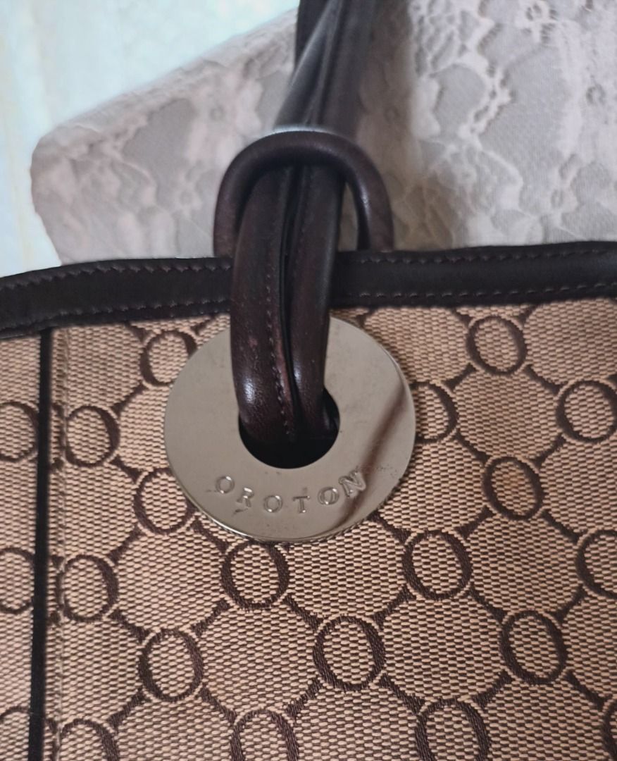 Oroton Monogram Canvas Leather Trim Tote Bag (Category: Luxury Bags & Wallets) located in Pasay City. Submitted by purefox-b7f3 (Listing ID 1443384109, Image 2). Description: - Oroton- Australian brand tote bag with signature monogram pattern - Brown leather trim and handles - Magnetic snap closure - Interior zippered pocket - Classic design, perfect for everyday use - Shows some signs of wear on leather trim and corners but is still very beautif