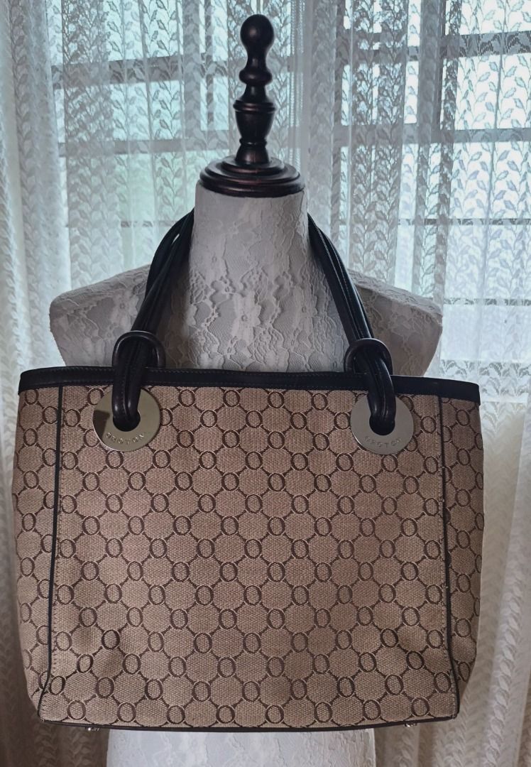 Oroton Monogram Canvas Leather Trim Tote Bag (Category: Luxury Bags & Wallets) located in Pasay City. Submitted by purefox-b7f3 (Listing ID 1443384109, Image 1). Description: - Oroton- Australian brand tote bag with signature monogram pattern - Brown leather trim and handles - Magnetic snap closure - Interior zippered pocket - Classic design, perfect for everyday use - Shows some signs of wear on leather trim and corners but is still very beautif