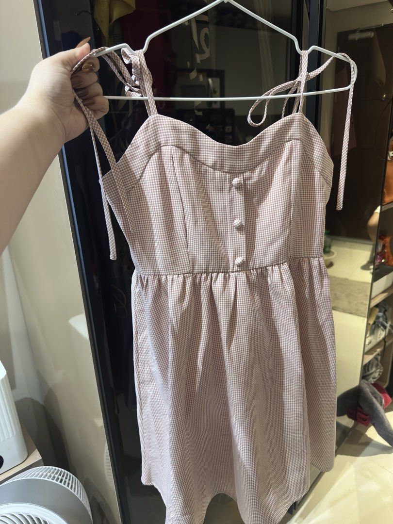 Pink Gingham Romper with Tie Straps (Category: Rompers) located in Cebu City. Submitted by declutter.queen888 (Listing ID 1443424137, Image 1). Description: - Adorable pink gingham romper - Features adjustable tie straps on shoulders - Functional button details down the front - Comfortable elasticated waist - Subtle textured fabric for added detail - Ideal for a relaxed, casual outing.