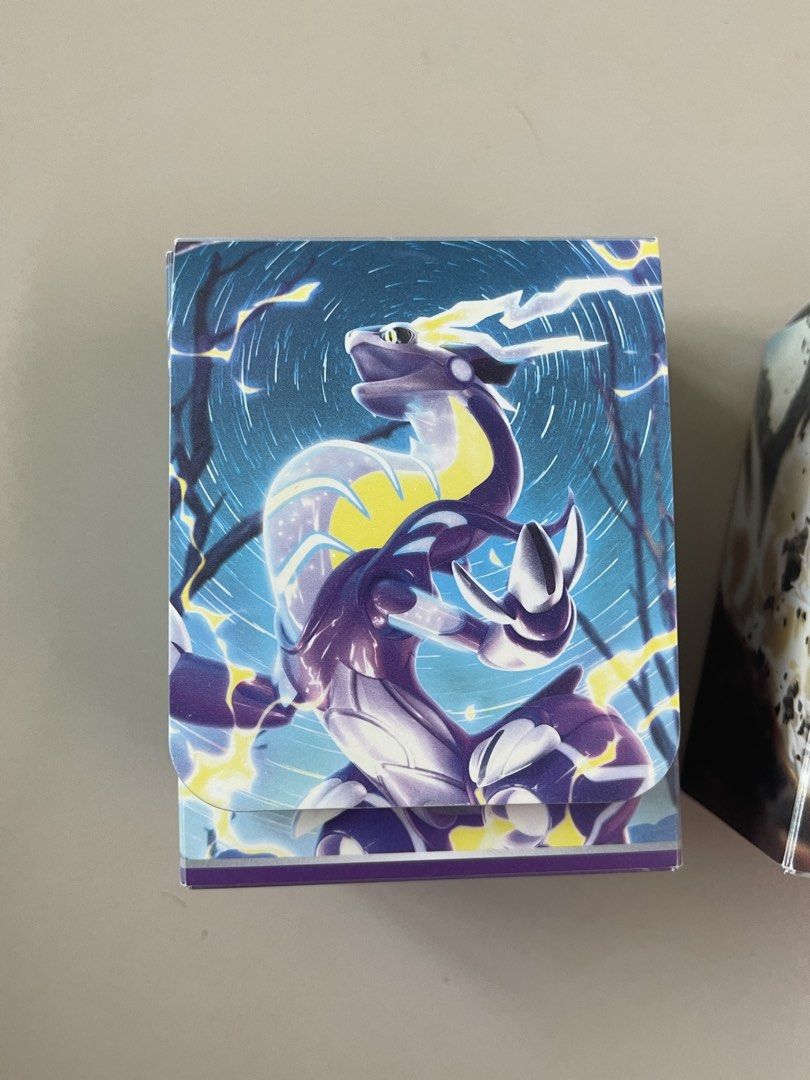 Pokemon Card Game Deck Boxes - Choose 1 for 500 (Category: Card Boxes & Cases) located in Manila. Submitted by shopandscore (Listing ID 1443346659, Image 2). Description: - Official Pokemon Card Game deck boxes - Three unique designs available: - Cool dragon design - Large creature with smaller mice - Cute mouse characters on a grid background - Keep your Pokemon cards organized and protected - Ideal for collectors and players in the Philippines.