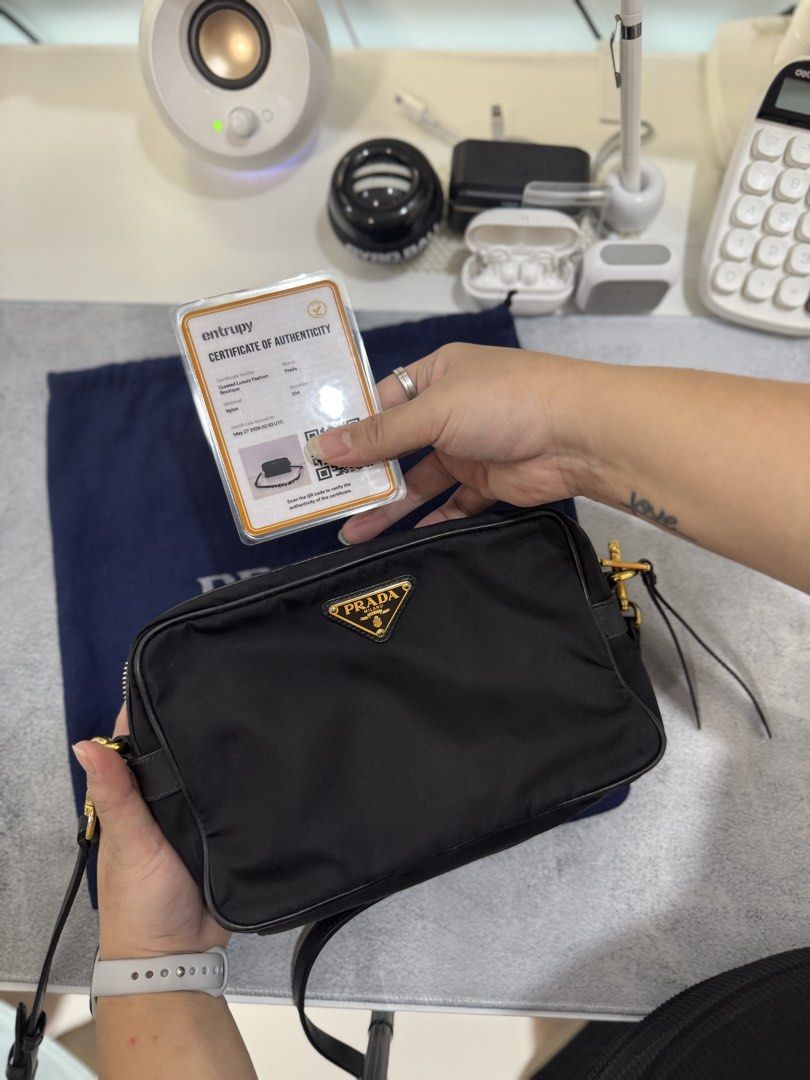Prada Nylon Crossbody Bag with Entrupy (Category: Luxury Bags & Wallets) located in Morong. Submitted by deegee1234 (Listing ID 1443340624, Image 1). Description: - Authentic Prada nylon crossbody bag - Features gold-tone hardware - Iconic Prada triangle logo - Leather trim and strap - Comes with original dust bag - Ideal for everyday use or travel - Spacious interior for essentials - 40-50k in online sellers With Entrupy RFS decluttering .