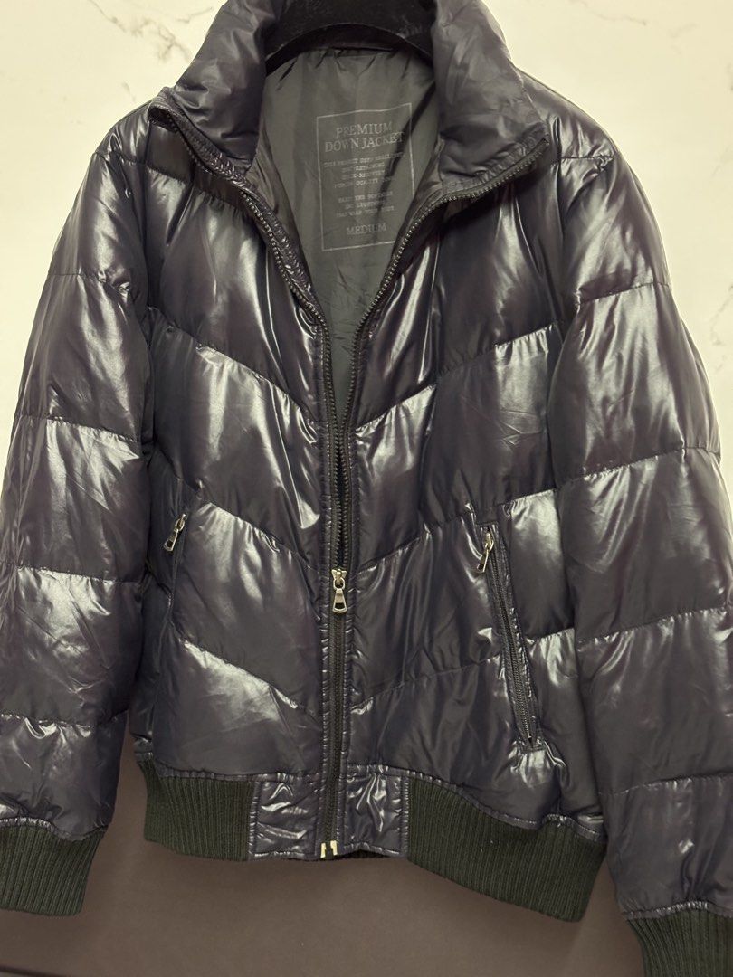 Premium Down Jacket Medium (Category: Coats, Jackets and Outerwear) located in Puchong. Submitted by putrydelrey (Listing ID 1443383182, Image 3). Description: - Dark navy puffer jacket - Stylish chevron quilting - Comfortable ribbed cuffs and hem - Convenient zipper closure with pockets - Premium down filling for warmth and lightness - Ideal for cold weather adventures.
