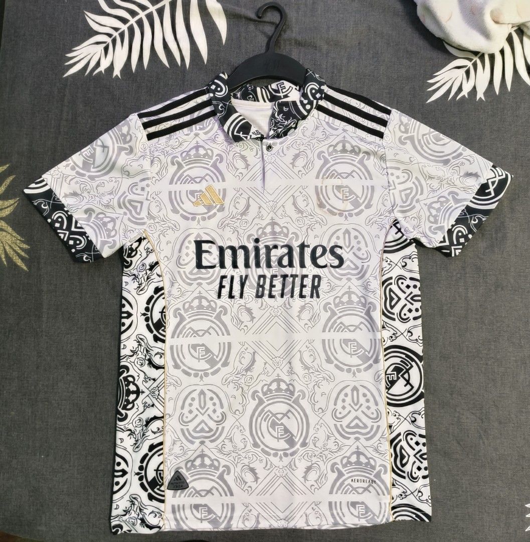 Real Madrid 22/23 Away Jersey Emirates Fly Better Adidas (Category: Activewear) located in Singapore. Submitted by prussy (Listing ID 1443458655, Image 1). Description: - Real Madrid Concept Jersey - Features Emirates Fly Better sponsor - Adidas branding included - Unique all-over pattern with club crest details - Ideal for any Real Madrid fan -Bought in Thailand -Unfortunately the real Madrid logo fell off hence the low price.