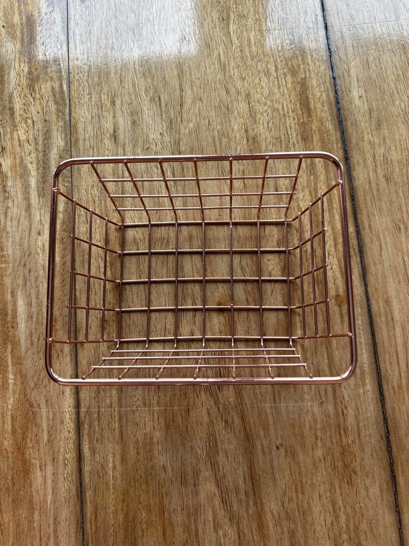 Rose Gold Wire Storage Basket Organizer (Category: Storage Boxes & Baskets) located in Manila. Submitted by ellie.copter (Listing ID 1443399593, Image 1). Description: - Cute rose gold wire basket - Perfect for organizing small items on your desk or vanity - Ideal for stationery, makeup, or small accessories - Features a simple grid design LxWxH: 8in x 6in x 3in.