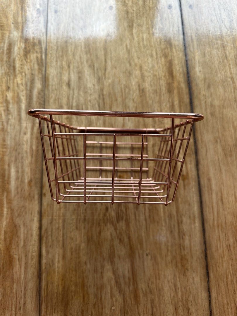 Rose Gold Wire Storage Basket Organizer (Category: Storage Boxes & Baskets) located in Manila. Submitted by ellie.copter (Listing ID 1443399593, Image 3). Description: - Cute rose gold wire basket - Perfect for organizing small items on your desk or vanity - Ideal for stationery, makeup, or small accessories - Features a simple grid design LxWxH: 8in x 6in x 3in.