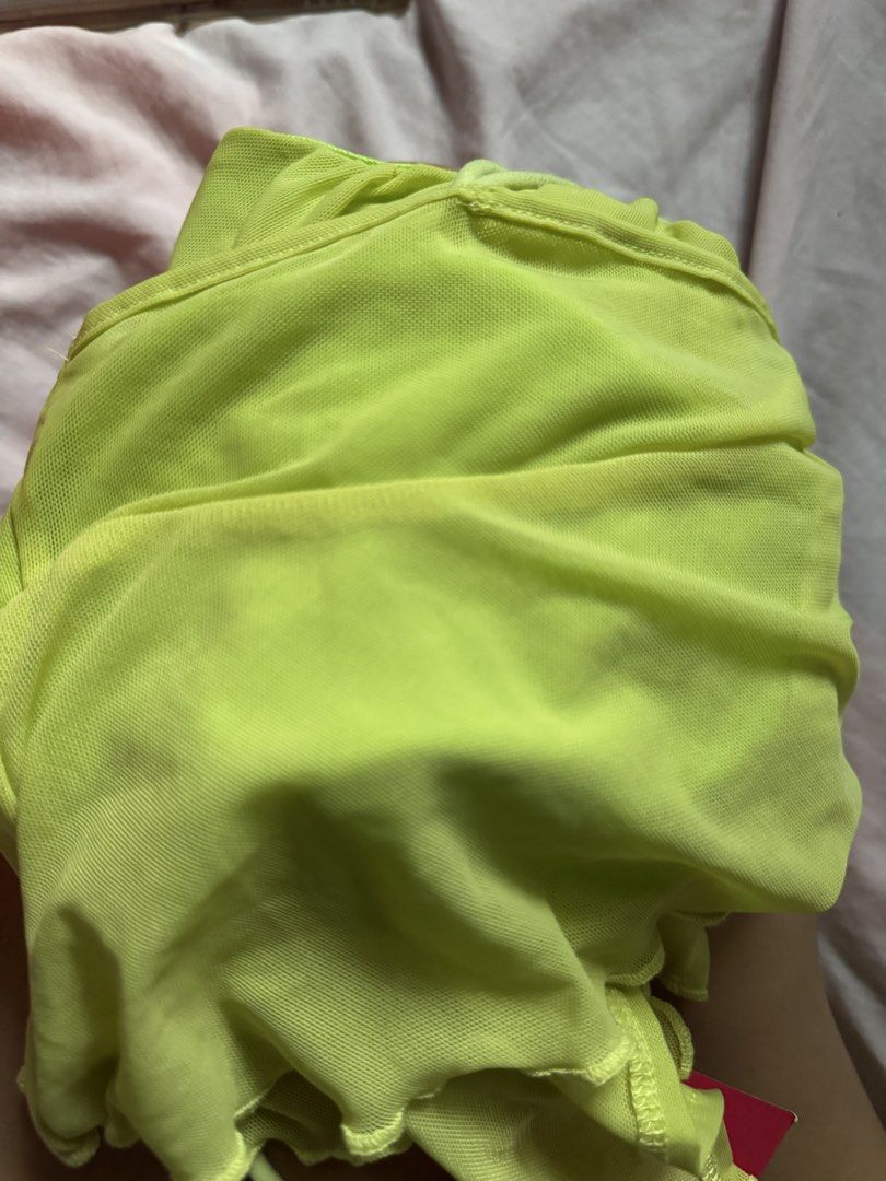 SHEIN ICON Lime Green Mesh Tie Front Crop Top (Category: Others Tops) located in Quezon City. Submitted by jamiin (Listing ID 1443414705, Image 3). Description: Can fit s-m - SHEIN ICON lime green mesh crop top - Adjustable tie front - Lettuce hem - Ruffle detail on bust - Thin spaghetti straps - Trendy for going out or festival looks - Versatile: pair with jeans or a skirt.