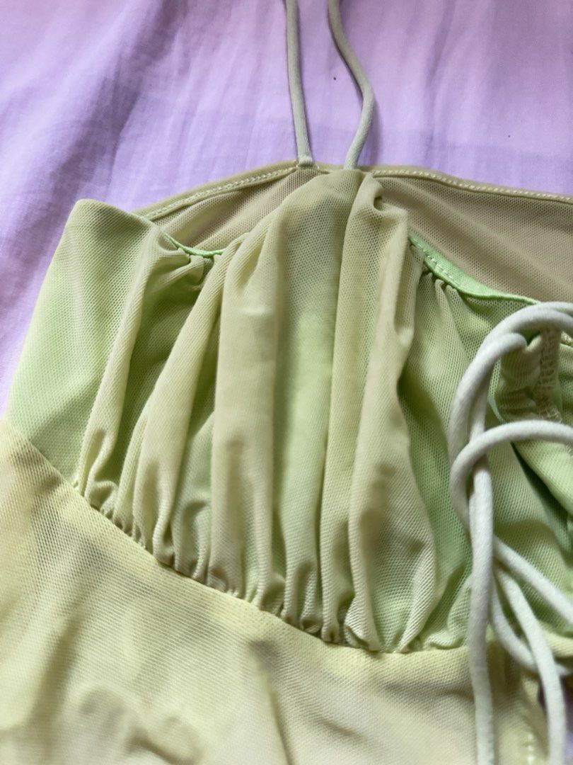 SHEIN ICON Lime Green Mesh Tie Front Crop Top (Category: Others Tops) located in Quezon City. Submitted by jamiin (Listing ID 1443414705, Image 2). Description: Can fit s-m - SHEIN ICON lime green mesh crop top - Adjustable tie front - Lettuce hem - Ruffle detail on bust - Thin spaghetti straps - Trendy for going out or festival looks - Versatile: pair with jeans or a skirt.