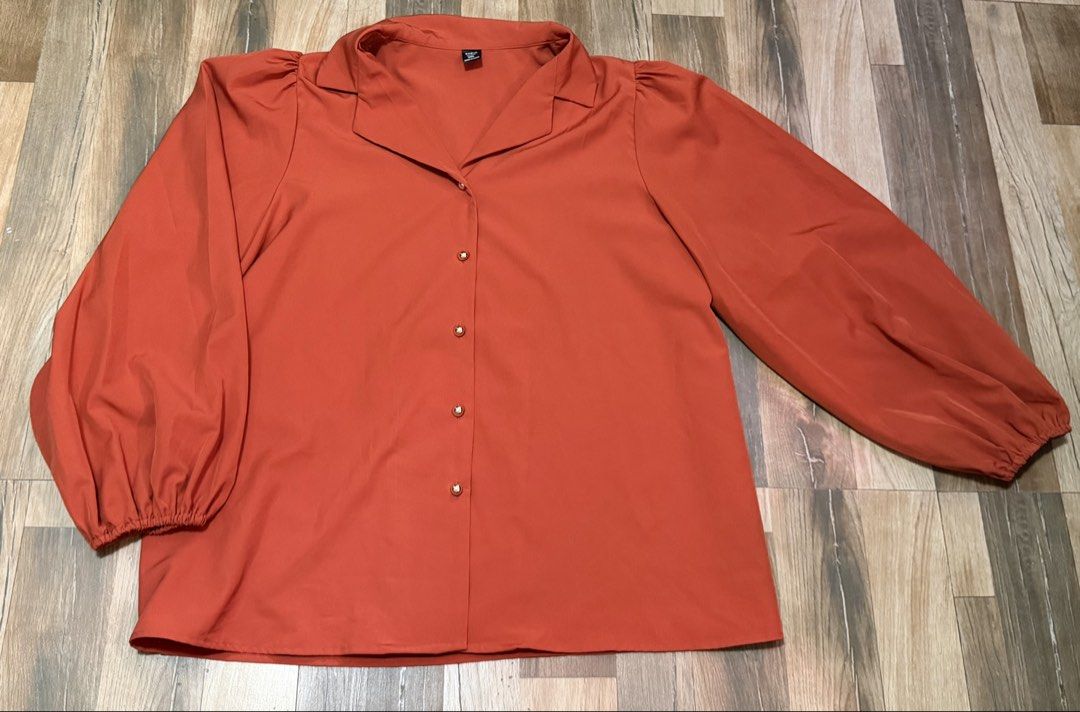 Shein Orange Puff Sleeve Collared Button-Up Blouse (Category: Blouses) located in Taytay. Submitted by shopbye (Listing ID 1443420744, Image 1). Description: - Stylish orange blouse - Features trendy puff sleeves - Classic collared neckline - Functional button-up front with elegant gold-toned buttons - Comfortable elasticated cuffs on sleeves - Versatile for both work and casual occasions - Easily dressed up or down.
