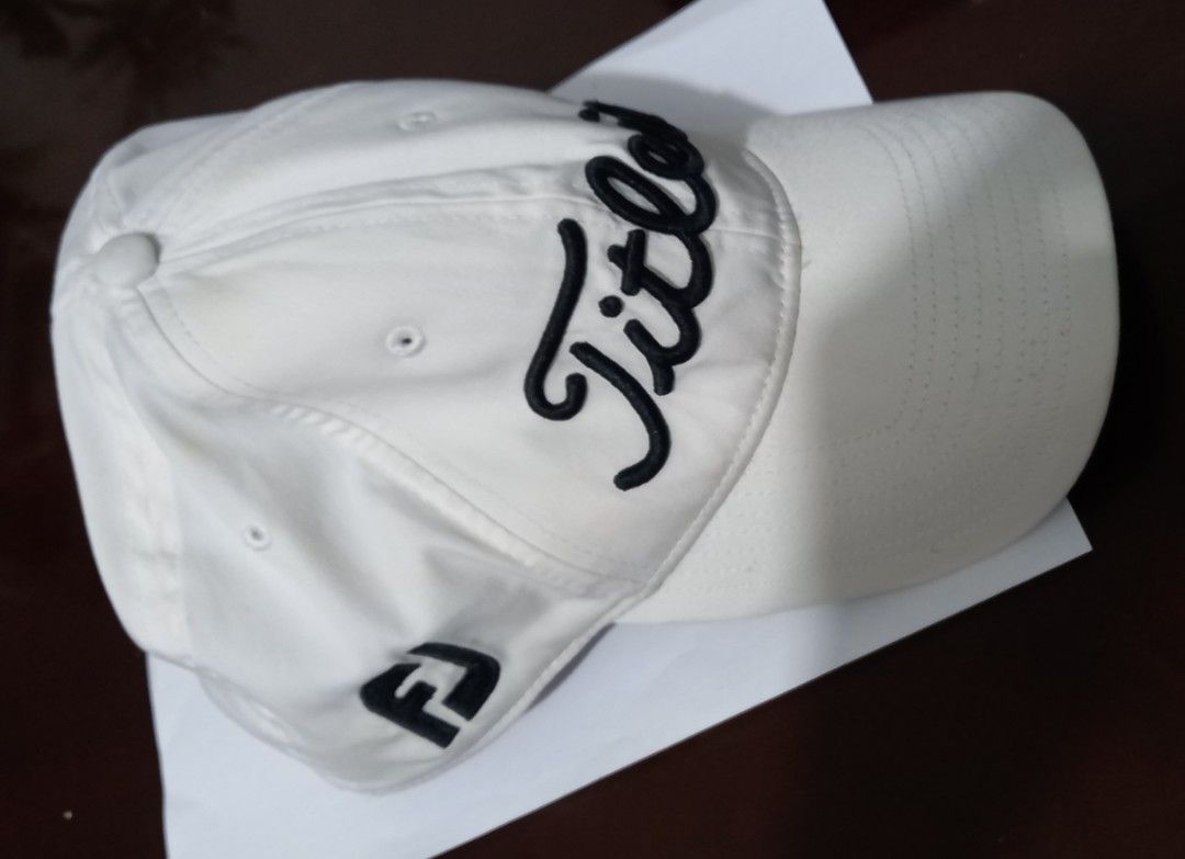 Titleist Pro V1 Golf Cap White (Category: Caps & Hats) located in Cagayan de Oro. Submitted by edwardryan01984 (Listing ID 1443447688, Image 3). Description: - Classic white Titleist Pro V1 cap - Features embroidered Titleist script logo on front - FJ logo detail on the side - Adjustable strap for a custom, comfortable fit - Ideal for sunny days and golf rounds.