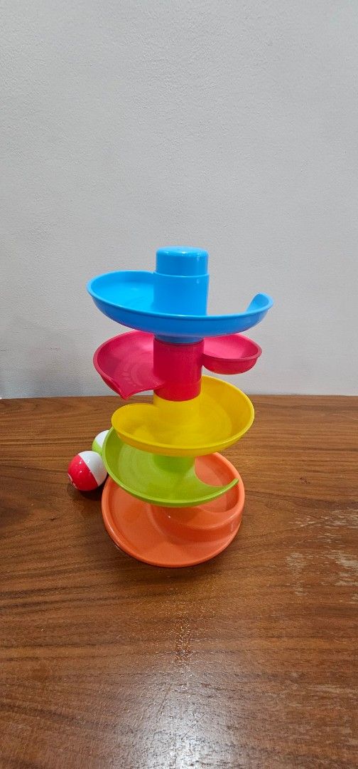 Top Bright Spiral Ball Drop Ramp Toy (Category: Kids Toys) located in Manila. Submitted by sheshe08 (Listing ID 1443431677, Image 3). Description: - Fun spiral ball drop toy for babies and toddlers. - Watch balls zoom down the ramps! - Bright colors to engage little ones. - Includes two balls. - Great for developing motor skills and understanding cause and effect. - Comes with original packaging..
