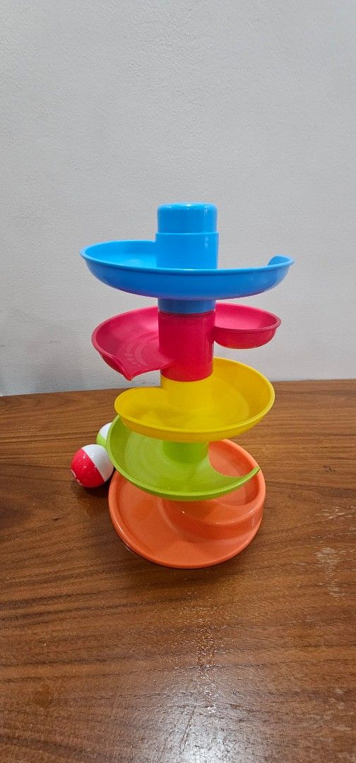 Top Bright Spiral Ball Drop Ramp Toy (Category: Kids Toys) located in Manila. Submitted by sheshe08 (Listing ID 1443431677, Image 2). Description: - Fun spiral ball drop toy for babies and toddlers. - Watch balls zoom down the ramps! - Bright colors to engage little ones. - Includes two balls. - Great for developing motor skills and understanding cause and effect. - Comes with original packaging..