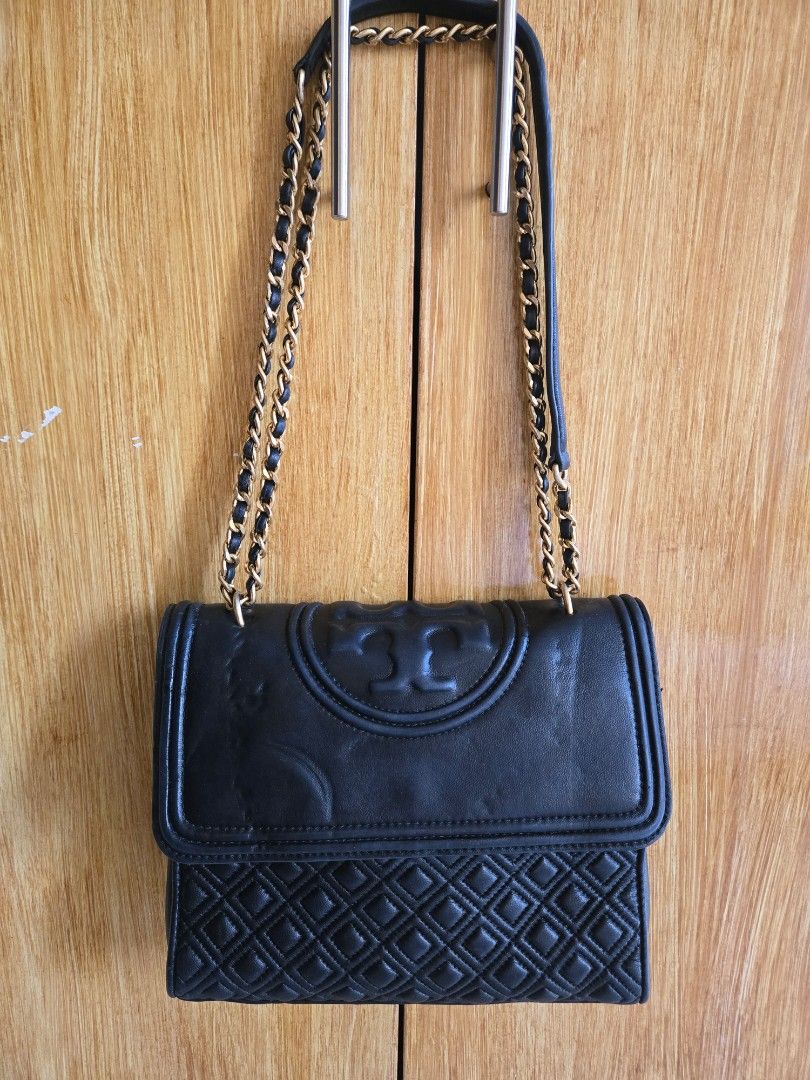 Tory Burch Fleming Medium Convertible Shoulder Bag (Category: Luxury Bags & Wallets) located in Cabuyao City. Submitted by brandedhanger (Listing ID 1443406946, Image 1). Description: Condition: - good condition - with minor signs of use and little cracks - Original - some pressmarks on the leather flap due to storage Details: Color: Black Hardware: Gold tone Material: Leather Approximate Dimensions in inches: H9 × W10 × D2.5 Color may vary due t