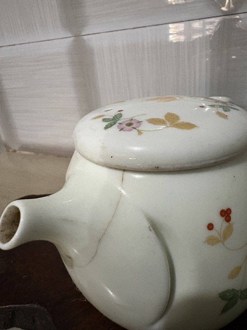 Vintage Ceramic Teapot with Floral Design (Category: Coffee & Tea Tableware) located in Bacoor. Submitted by dawnandust (Listing ID 1443333235, Image 3). Description: - Adorable ceramic teapot with a charming floral and berry design. - Ideal for serving small portions of tea. - Features a lid with small, functional holes. - Stands approximately 6 inches tall. - Versatile piece, perfect for both display and practical use..