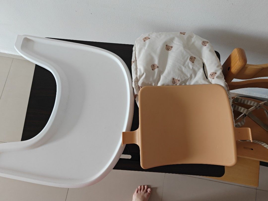 Accessories for Stokke Trip Trapp inspired high chair (Category: Baby High Chairs) located in Singapore. Submitted by junieloon (Listing ID 1443504637, Image 2). Description: - Stokke Tripp Trapp inspired accessories set - Includes: White tray, beige/grey striped harness, bear-print seat cushion - Harness features a secure 5-point buckle - Ideal for keeping your child safe and tidy during meals - High chair NOT included.